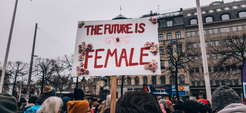 "the future is female" sign at rally