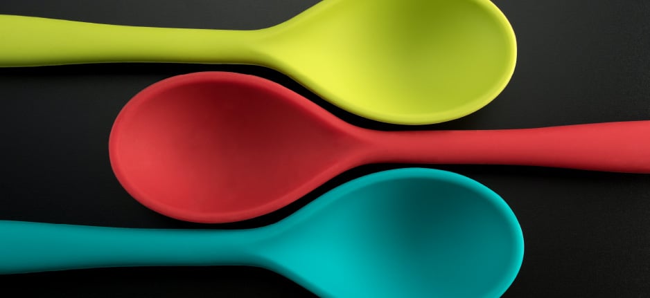 colorful spoons on black background